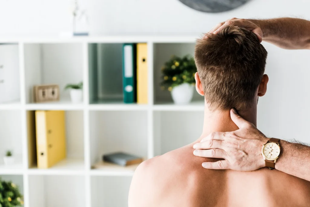cropped view of doctor touching neck of shirtless
