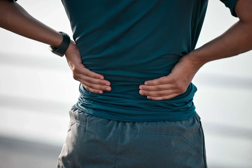 man holding back suffering